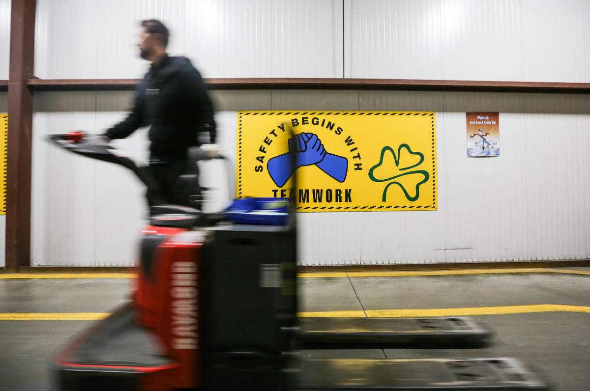 Safety begins with teamwork sign hanging in Flanagan Foodservice warehouse
